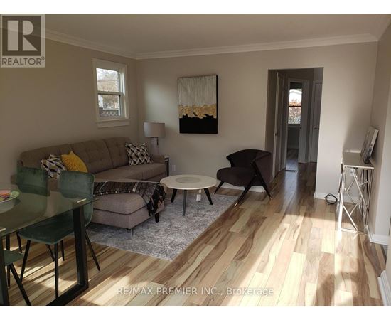 A living room with a couch, chairs, and a coffee table.
