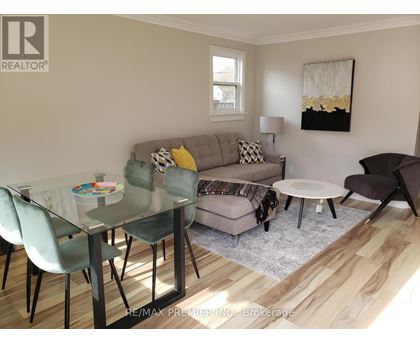 A modern living room with a glass table and chairs.