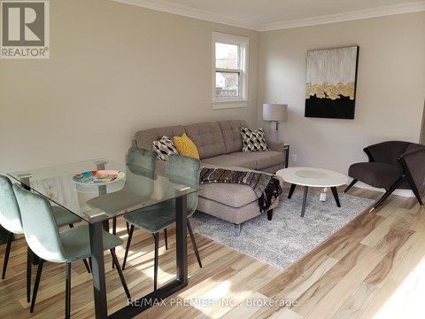 A modern living room with a glass table and chairs.