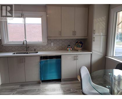 A kitchen with a blue refrigerator and white cabinets.