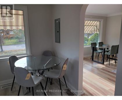 A dining room with a glass table and chairs.