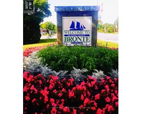 A sign welcoming people to Bronte surrounded by flowers.
