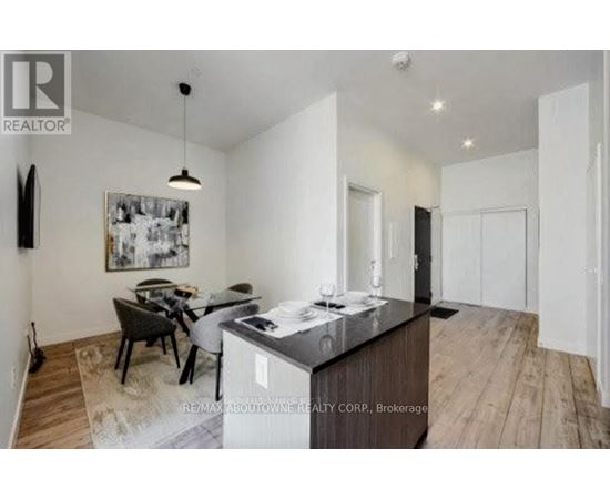 A modern kitchen with a dining table and chairs.