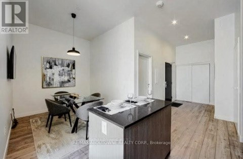A modern kitchen with a dining table and chairs.