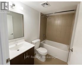 A small bathroom with a toilet, sink, and bathtub.