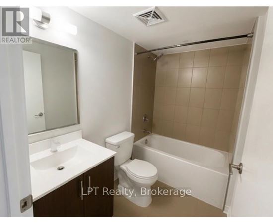 A small bathroom with a toilet, sink, and bathtub.