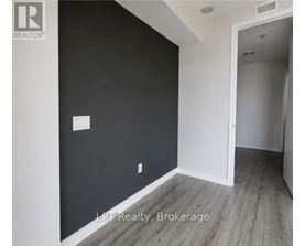 A room with a white door and a black wall.