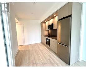 A kitchen with wooden floors and stainless steel appliances.