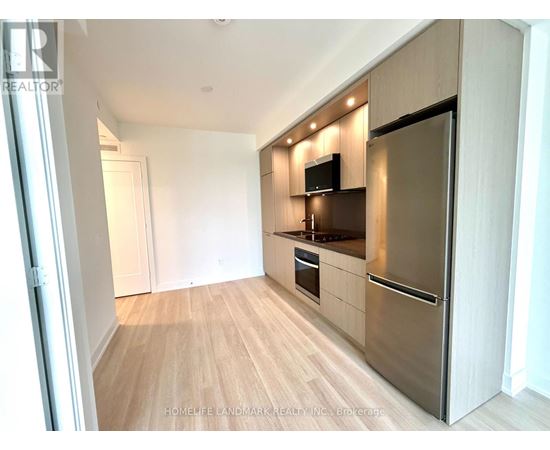A kitchen with wooden floors and stainless steel appliances.