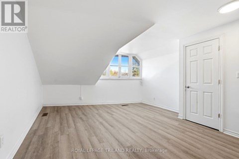 A white room with a door and a window.