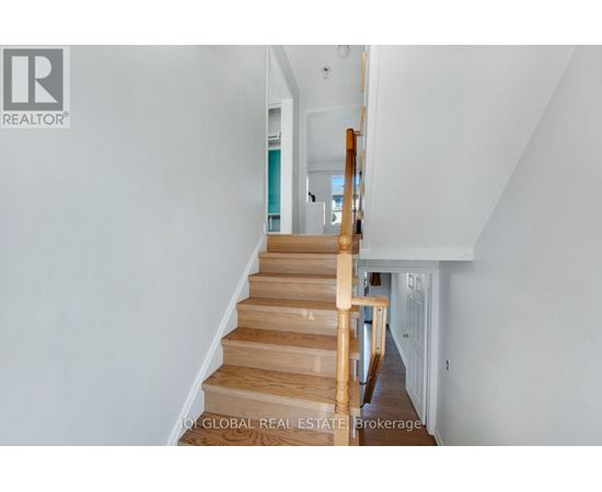 A staircase with wooden steps and handrails.