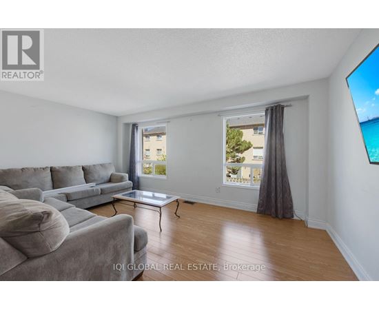 A living room with a grey couch and a coffee table.