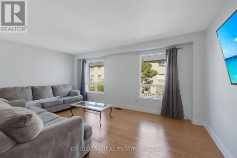 A living room with a grey couch and a coffee table.