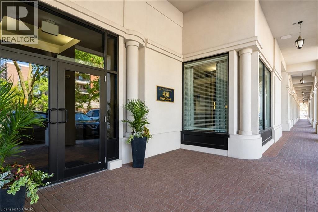 A building entrance with a glass door and a sign that says REALTOR.