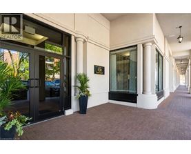 A building entrance with a glass door and a sign that says REALTOR.