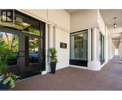 A building entrance with a glass door and a sign that says REALTOR.