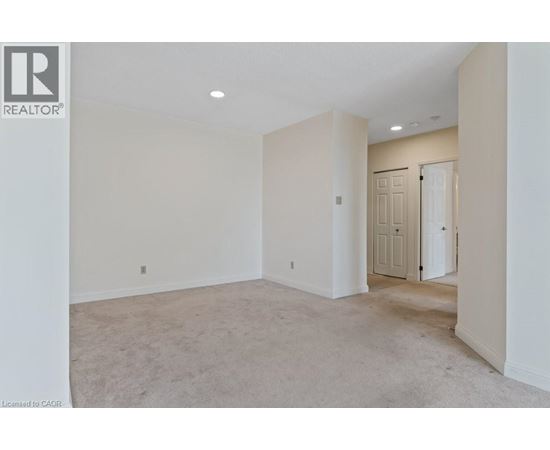 A spacious room with a door on the right side.