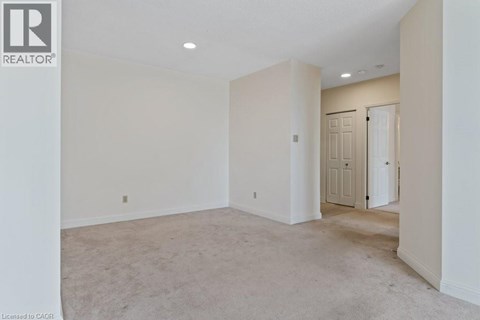 A spacious room with a door on the right side.