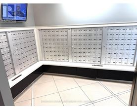 A row of mailboxes are lined up on a wall.