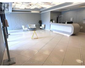 A reception area with a white reception desk and a yellow caution tape on the floor.