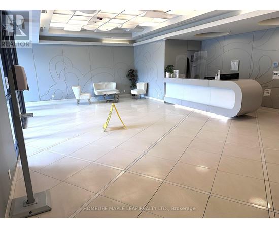 A reception area with a white reception desk and a yellow caution tape on the floor.