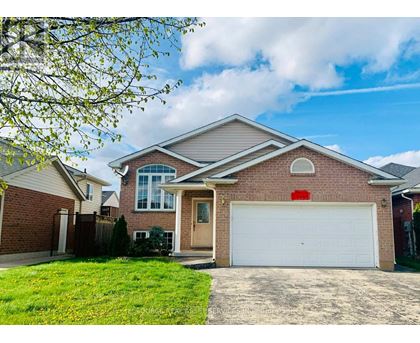 A house with a white garage door and a brown brick exterior.