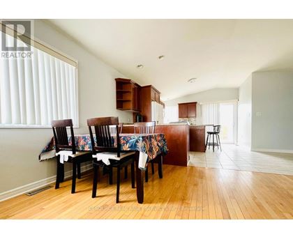 A dining room with a table set for four.