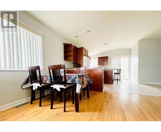 A dining room with a table set for four.