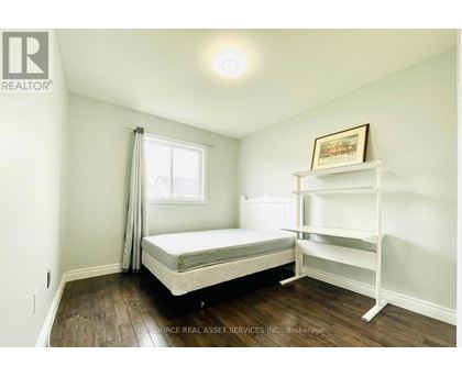 A bedroom with a bed and a shelf.