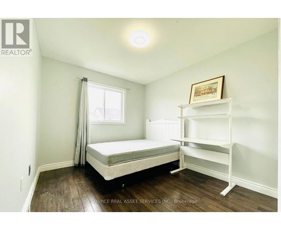 A bedroom with a bed and a shelf.