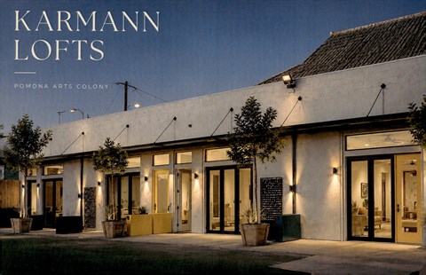 Karmann Lofts Pomona Arts Colony is a modern building with a lot of windows and doors.