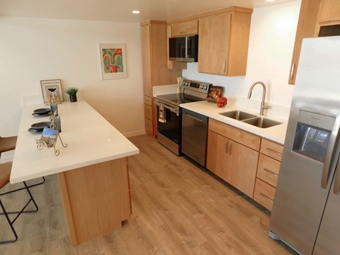 A kitchen with wooden cabinets and a white countertop.