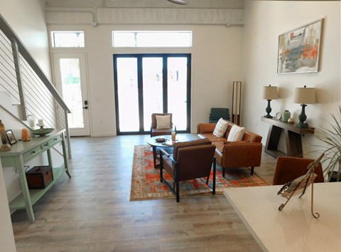 A living room with a brown couch and a white table.