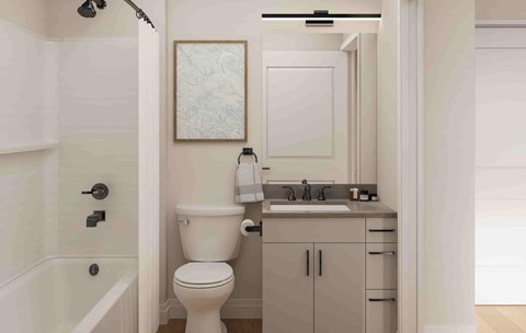 A white bathroom with a toilet, sink, and bathtub.
