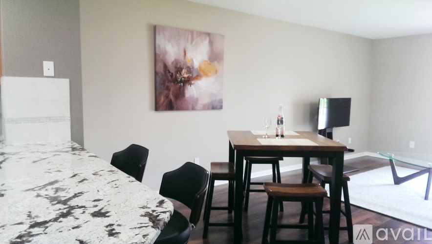 A dining area with a table and chairs.