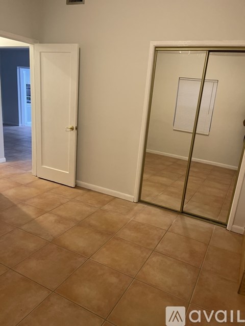 A room with a tiled floor and a white door.