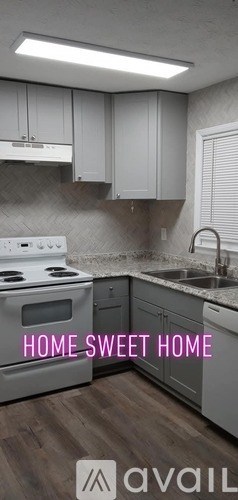 A kitchen with white cabinets and a stove top oven.