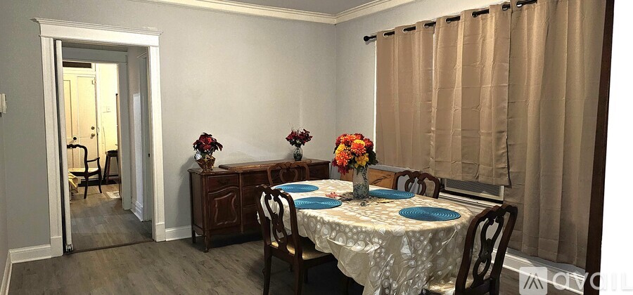 A dining room with a table set for two.