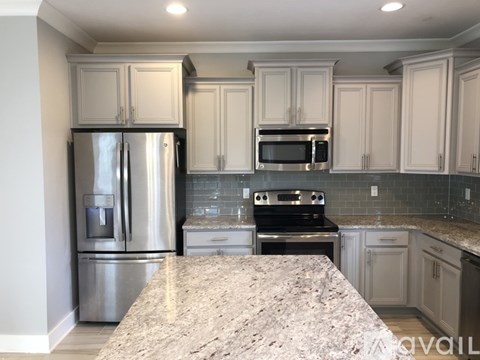 A kitchen with granite countertops and stainless steel appliances.