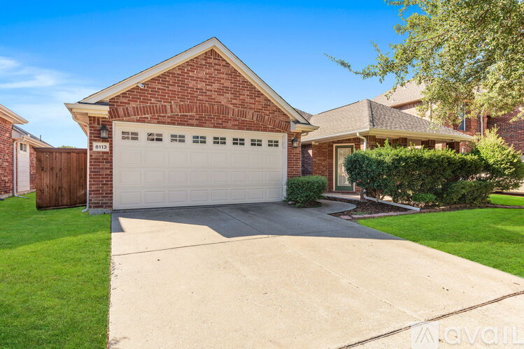 A house with a garage and a driveway in front.