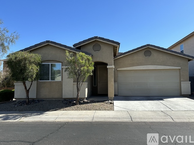 A house with a garage and a driveway in front.