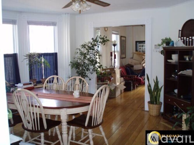 A dining room with a round table and chairs.