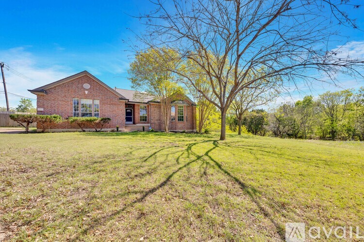 A house with a tree in front of it is for sale.