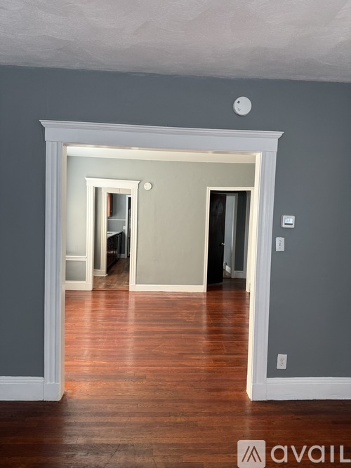 A room with wooden floors and grey walls.