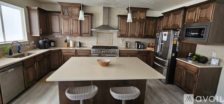 A kitchen with wooden cabinets and a central island.