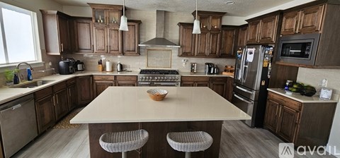 A kitchen with wooden cabinets and a central island.