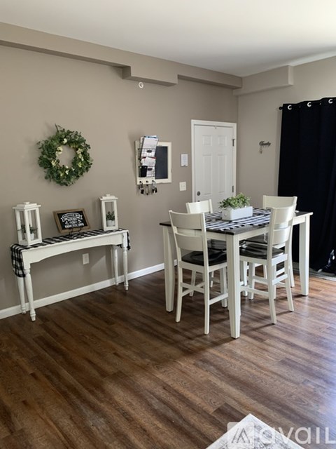 A dining room with a table and chairs.