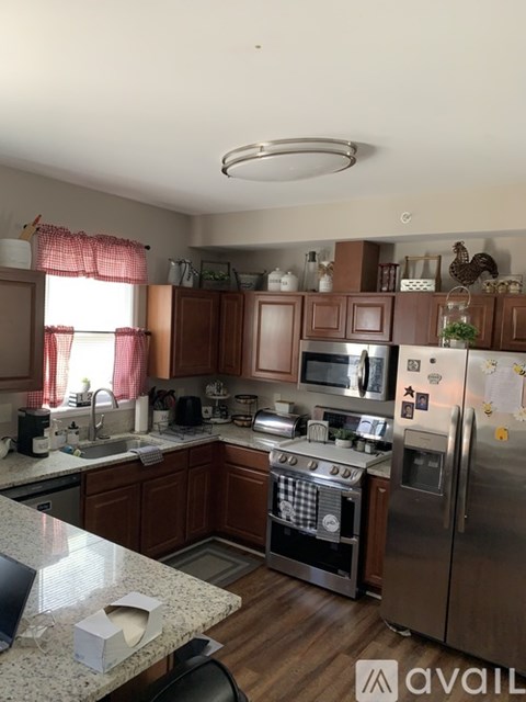 A kitchen with wooden cabinets and granite countertops.