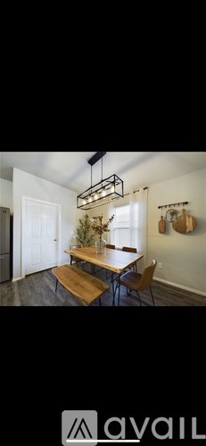 A dining area with a wooden table and chairs.