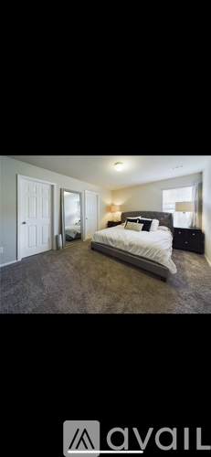 A bedroom with a bed, dresser, and mirror.